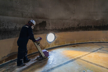Male worker inspection floor scan tank external floating of rust  wall lose thickness bottom plate...