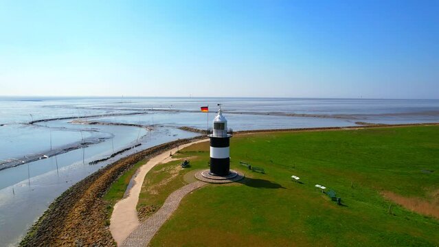 Little Preusse lighthouse - Wurster North Sea coast - Wremen - Northern Germany - Aerial view of the black and white sea mark at the cutter harbor