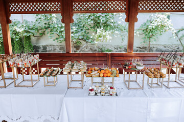 open-air buffet table, sandwiches on skewers before the start of the holiday against the background...