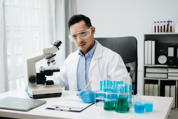 Modern medical research laboratory. male scientist working with micro pipettes analyzing...