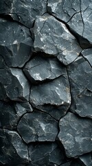 Black and grey rock surface with cracks and crevices
