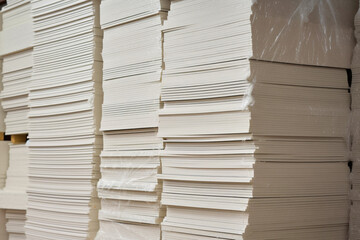 Stacks of white extruded polystyrene sheets insulative material for buildings stored in warehouse