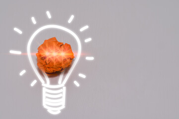 New ideas and Creative thinking innovation concept. Paper scrap ball orange colour with light bulb symbol on white background