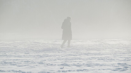A silhouette in fog in winter