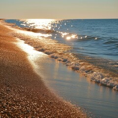 glimmering sea waves reaching the sandy beach at sunset