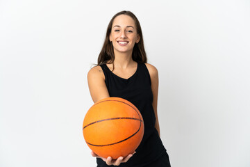 Young hispanic woman over isolated white background playing basketball