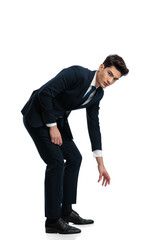 elegant businessman in suit trying to take something from the floor