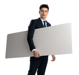 confident sexy man in suit holding white empty board under his arm