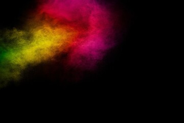Explosion of colorful pigment powder on black background.Vibrant color dust particles textured...