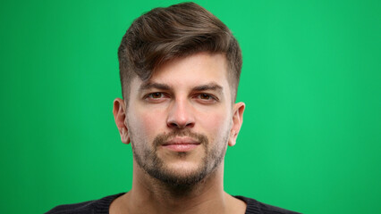 Man's face, close-up, on a green background