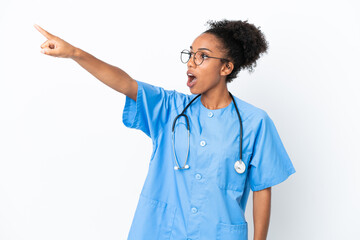 Young surgeon African American doctor woman isolated on white background pointing away