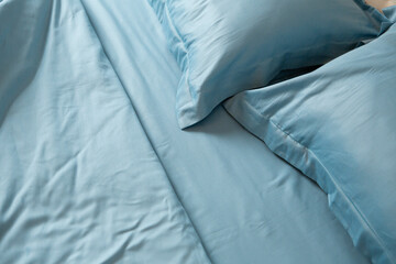Close up of Messy bed blue cotton crumpled fabric - 722033086