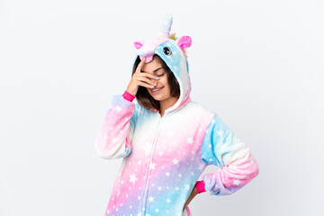 Young caucasian woman wearing a unicorn pajama isolated on white background laughing