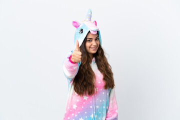 Young caucasian woman wearing a unicorn pajama isolated on white background with thumbs up because something good has happened