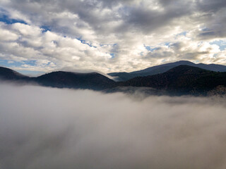 Aerial view of a mountain in the fog, Tuscany, Italy. - 722049846