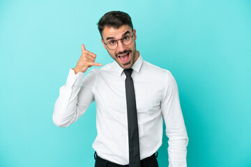 Business caucasian man isolated on blue background making phone gesture. Call me back sign
