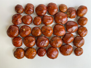Bean of Archidendron pauciflorum, djenkol, jengkol or blackbead. Isolated on white background, flat lay or top view