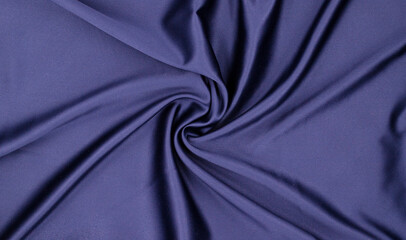 Background texture from folds of delicate blue silk fabric, top view