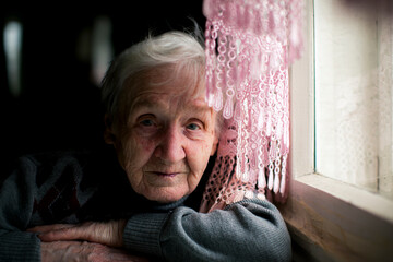 Portrait of an elderly woman near a window.