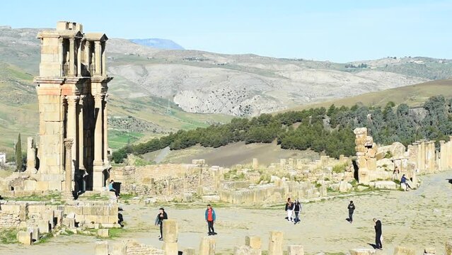 High-angle footage of tourists on a walking tour in the ancient Roman town of Djemila. Setif, Algeria. UNESCO World Heritage Site.