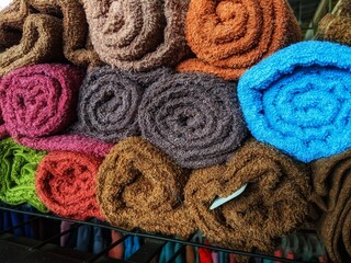 Rolled towels on the shelf neatly arranged