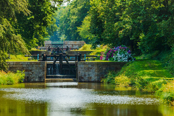 Tourist site of the Ille-et-Rance canal, The eleven locks, in Hédé Bazouges, between Saint-Malo and Rennes. The lock keepers maintain the surroundings and make many flower screens bloom.