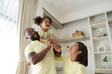 Family Leisure. Happy Black Mom, Dad And Little Daughter Having Fun At Home Together, African American Father, Mother And Cute Female Child Playing In Living Room And Smiling At Camera, Free Space