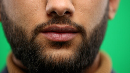 Obraz premium Man's mouth, close-up, on a green background