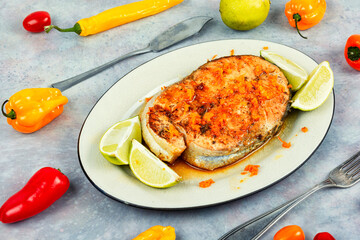 Salmon or trout steak in orange marinade.