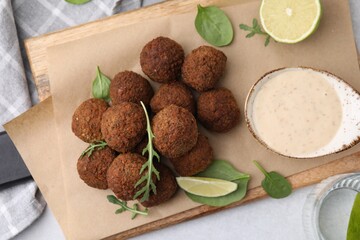 Delicious falafel balls served on light table, top view