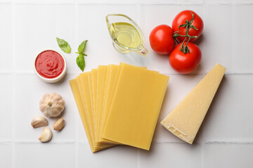 Ingredients for lasagna on white tiled table, flat lay