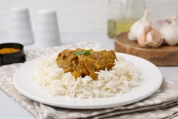 Delicious chicken curry with rice on table, closeup