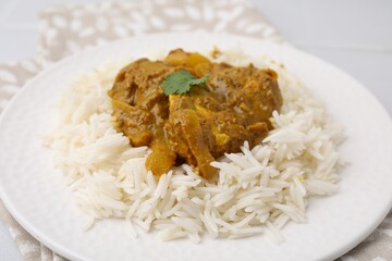 Delicious chicken curry with rice on table, closeup