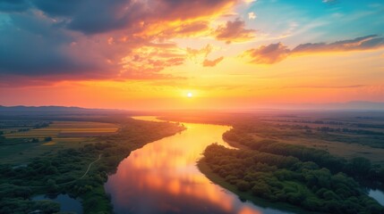 Beautiful landscape with sunset or sunrise river valley dawn or dusk over the peaceful calm still waters and blue and yellow sky horizon reflecting with clouds
