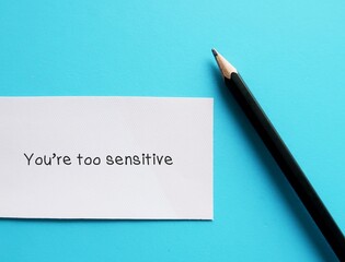 Card on blue background with handwriting YOU ARE TOO SENSITIVE - gaslighting way to accuse or...