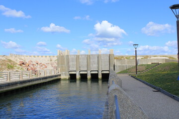 a modern fish passage of river durdent to the sea for reproduction at the french coast in veulettes-sur-mer in normandy and a blue sky
