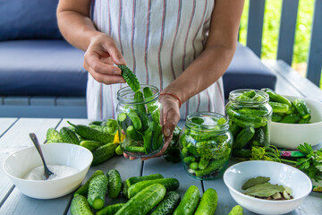 Preserving cucumbers in jars. Selective focus.