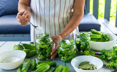 Preserving cucumbers in jars. Selective focus.