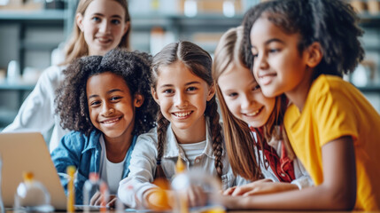 Back to school, group of 5 cheerful primary students multiethnic studying in modern science laboratory lab classroom with blackboard background using laptop, children girls enjoy experimenting