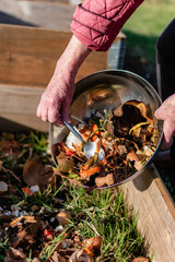 Person who put in a composter some kitchen waste like vegetables, fruits, eggshell, coffee grounds...