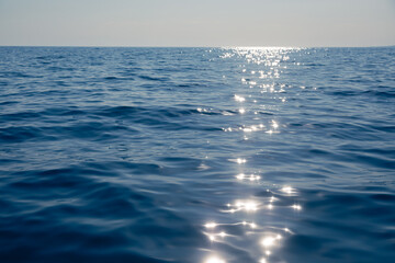 Tranquil sea with glistening sun reflection natural background