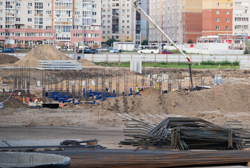 Concreting work at the construction site. Construction workers pour liquid concrete from cement...