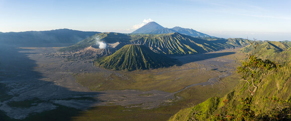 Panoramic view of a majestic volcanic landscape with a smoking crater.