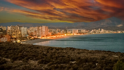 View of San Juan beach and water front buildings on the Mediterranean coast of Alicante, Spain, at dusk
