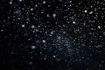 Snowfall on black background. Snowflakes on black background