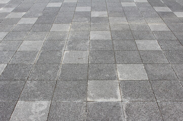 Texture of square cobblestone. Pattern of gray sidewalk tiles in the street. Gray square...