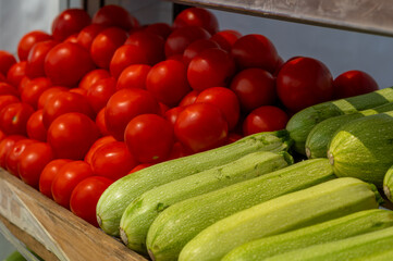 Tomatoes and zucchini in the window on the street.