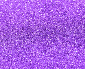 Purple violet glitter shining light sparking texture background. New Year, Christmas and Celebration background concept. 