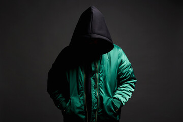 Stylish Man in Black Hood and green bomber jacket. Trendy wear Boy