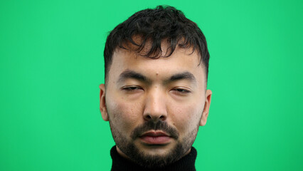 Man's face, close-up, on a green background